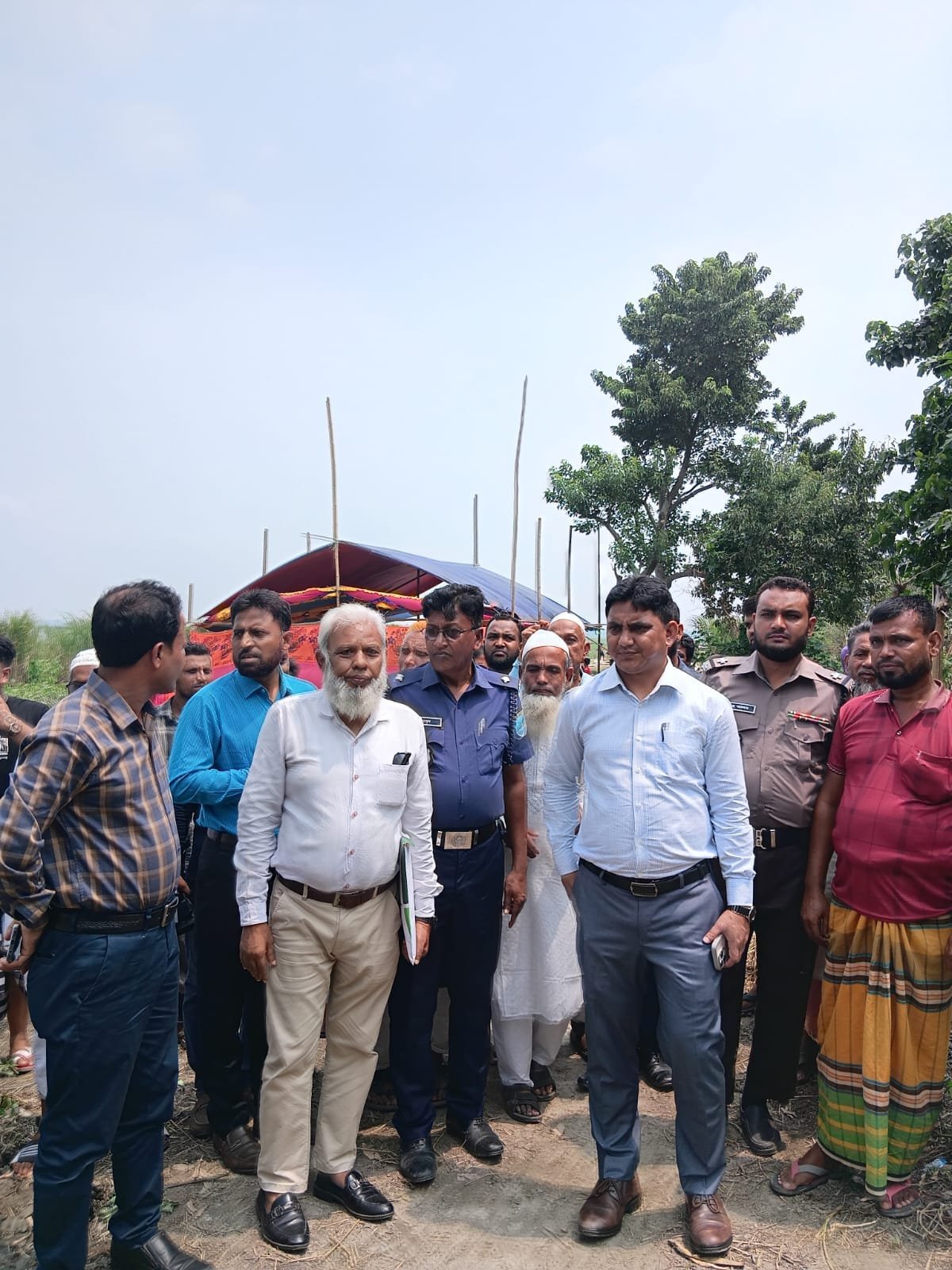 Field visit; elderly official with group.